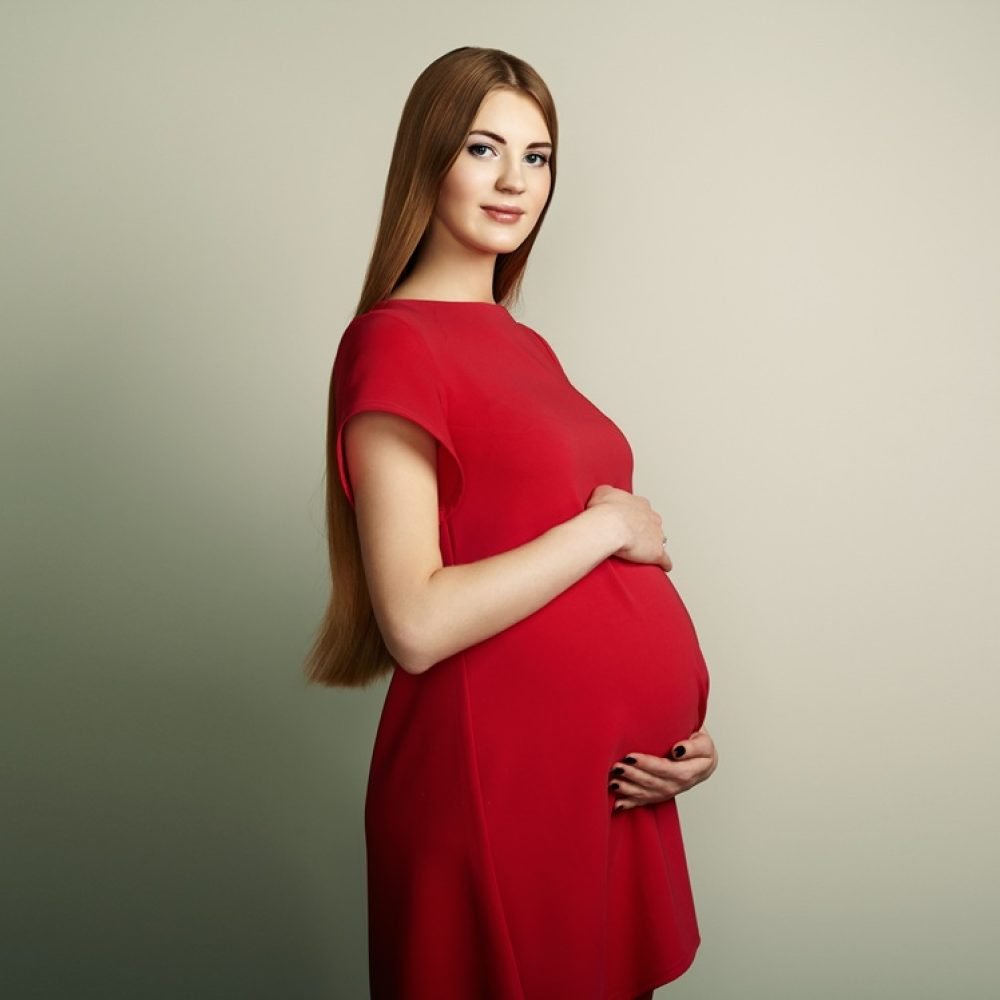 Portrait of the young pregnant woman. Pregnancy, love, people and expectation concept. Happy pregnant lady with long hair